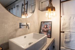 a bathroom with a white sink and a mirror at Open Space Mi Alma Lake View in Toscolano Maderno