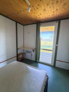 a bedroom with a bed and a window and a desk at Ferme de L'Aoueille in Pouylebon