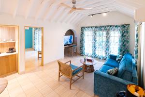 a living room with a blue couch and a table at Fourways Inn in Chelston