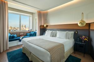 a hotel room with a large bed and a window at Only YOU Hotel Valencia in Valencia +70 photos