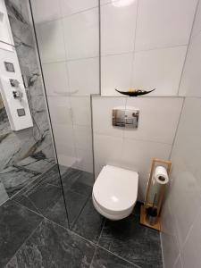 a bathroom with a toilet and a shower at Olive II Apartman in Alsóörs +31 photos