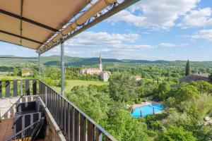 a view from the balcony of a villa with a pool at Le Mas Boyer in Chauzon