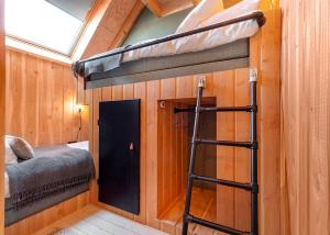 a room with a bunk bed and a ladder at Lennepserf - T Farrel in Veessen +6 photos