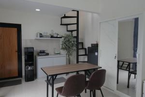 a dining room with a wooden table and chairs at Abata Villa Panorama & Pool in Tingkirtengah