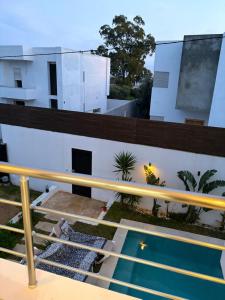 a view from the balcony of a building with a swimming pool at Dar Selima Hammamet in Hammamet
