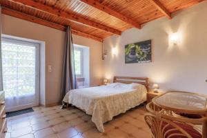 a bedroom with a bed and a large window at Le Mas Boyer in Chauzon +138 photos