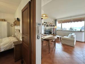 a room with a bed and a table and a living room at La terrazza su Assisi in Assisi +3 photos