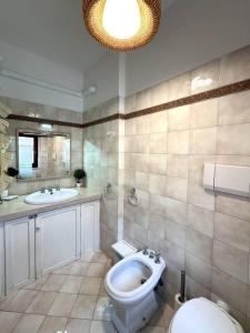 a bathroom with a toilet and a sink at La terrazza su Assisi in Assisi