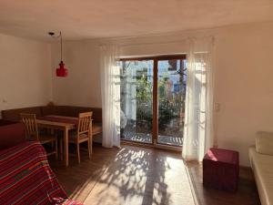 a living room with a couch and a table and a window at Bungaloase in Kelheim