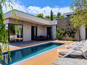 a house with a swimming pool and a patio at Rezidenca - Villa Cape Of Rodon in Draç