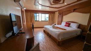 a bedroom with a bed and a flat screen tv at Tiger Complex Hotel and Restaurant in Patong Beach