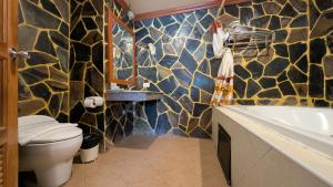 a bathroom with a toilet and a sink and a tub at Tiger Complex Hotel and Restaurant in Patong Beach +58 photos