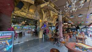 a restaurant with tables and chairs in a building at Tiger Complex Hotel and Restaurant in Patong Beach