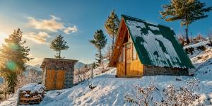 a log cabin in the snow with a building at Hima 360, A Frame Cabin, Panaromic Sainj Valley Views, Bhatkanda in Sainj +44 photos