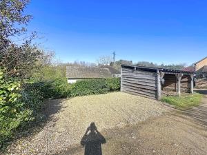 a shadow of a person standing in front of a shed at Charming studio Terrace and parking in Le Mans +3 photos