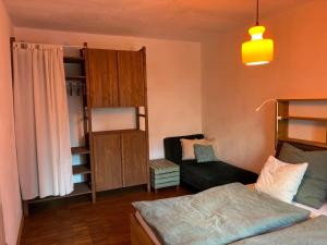 a bedroom with a bed and a chair in it at Bungaloase in Kelheim