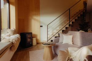 a living room with a couch and a table at Monside Resort - AIR CABIN in Borzont