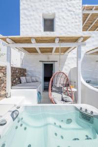 a jacuzzi tub on the patio of a house at Plaka Suites in Plaka Milou