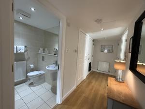a bathroom with a toilet and a sink at Tolbooth Apartments by Principal Apartments in Glasgow +254 photos