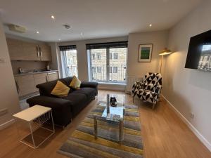 a living room with a couch and a table at Tolbooth Apartments by Principal Apartments in Glasgow
