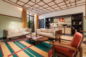 a living room with a couch and a table at La Maison Palmier Abidjan, a Member of Design Hotels in Abidjan