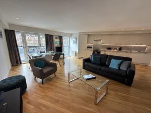 a living room with a couch and a table at Tolbooth Apartments by Principal Apartments in Glasgow