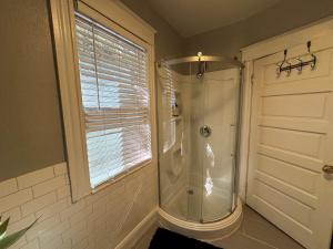 a shower in a bathroom with a window at Downtown Lake Eola Historic House 1 OR 2 BED in Orlando +7 photos