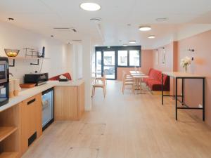a kitchen and living room with tables and chairs at City Pop 2Night Paris - Self check-in in Vanves