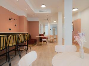 a room with a bar with chairs and a table at City Pop 2Night Paris - Self check-in in Vanves