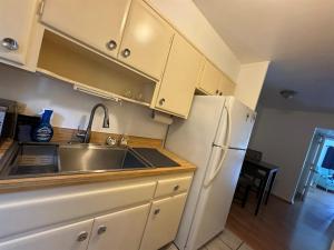 a kitchen with a sink and a refrigerator at Retro lake Eola 1 Bedroom Condo Thornton park in Orlando