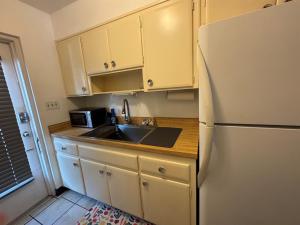 a kitchen with a sink and a refrigerator at Retro lake Eola 1 Bedroom Condo Thornton park in Orlando +8 photos
