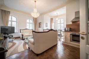 a large living room with a couch and a kitchen at Villa Rosenburg in Thale