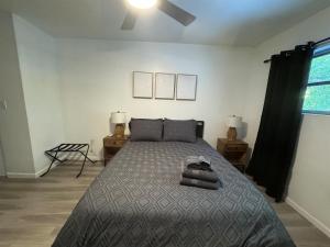 a bedroom with a bed and two tables and a window at Location Lake Eola View 1 Bedroom condo in Orlando