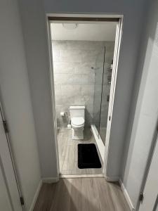 a bathroom with a toilet and a glass shower at Location Lake Eola View 1 Bedroom condo in Orlando
