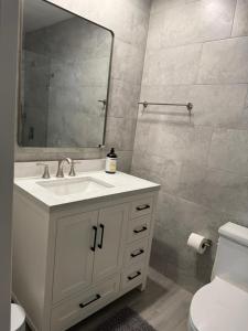 a bathroom with a white sink and a mirror at Location Lake Eola View 1 Bedroom condo in Orlando