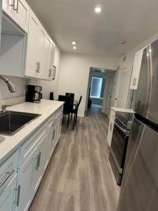 a kitchen with white cabinets and a counter top at Location Lake Eola View 1 Bedroom condo in Orlando +18 photos