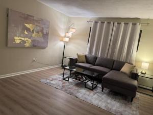 a living room with a couch and a table at Vintage 2 Bedroom Condo Lake Eola View in Orlando