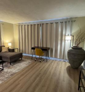 a living room with a desk and a couch and a table at Vintage 2 Bedroom Condo Lake Eola View in Orlando