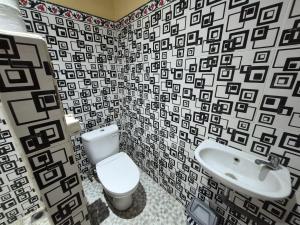 a bathroom with a toilet and a sink at Muka House in Ubud +57 photos