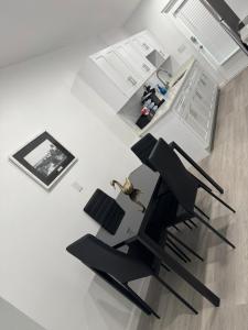 a room with two black chairs and a table at Renovated Condo Lake Eola View Great Location in Orlando