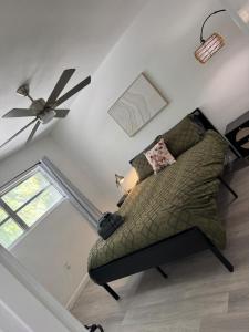 a living room with a couch and a ceiling fan at Renovated Condo Lake Eola View Great Location in Orlando
