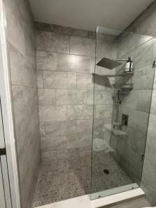 a shower with a glass door in a bathroom at Renovated Condo Lake Eola View Great Location in Orlando +20 photos
