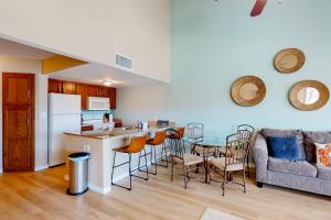 a kitchen and living room with a table and chairs at Gulf Point Condominiums in South Padre Island