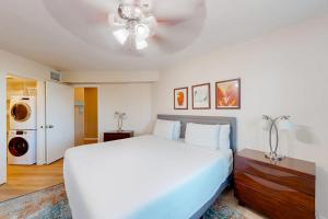 a bedroom with a white bed and a ceiling fan at Gulf Point Condominiums in South Padre Island +21 photos