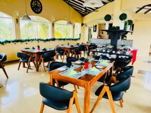 a restaurant with tables and chairs in a room at The Ocean Pearl Hotel Negombo in Negombo