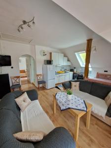 a living room with a couch and a table at Landhaus Forrás in Balatonfüred