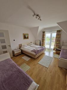 a bedroom with a large bed and a large window at Landhaus Forrás in Balatonfüred +13 photos