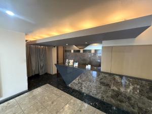 a lobby with a marble counter in a building at Hotel Orchid (Adult only) in Kurashiki