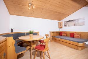 a living room with a table and a couch at Alpenrelax Krepperhütte in Volders