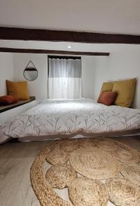 a bedroom with a large bed with a large rug at Cocooning et Charmante Maisonnette Provençale, avec Extérieurs privatifs et Accès Piscine in Orgon +27 photos
